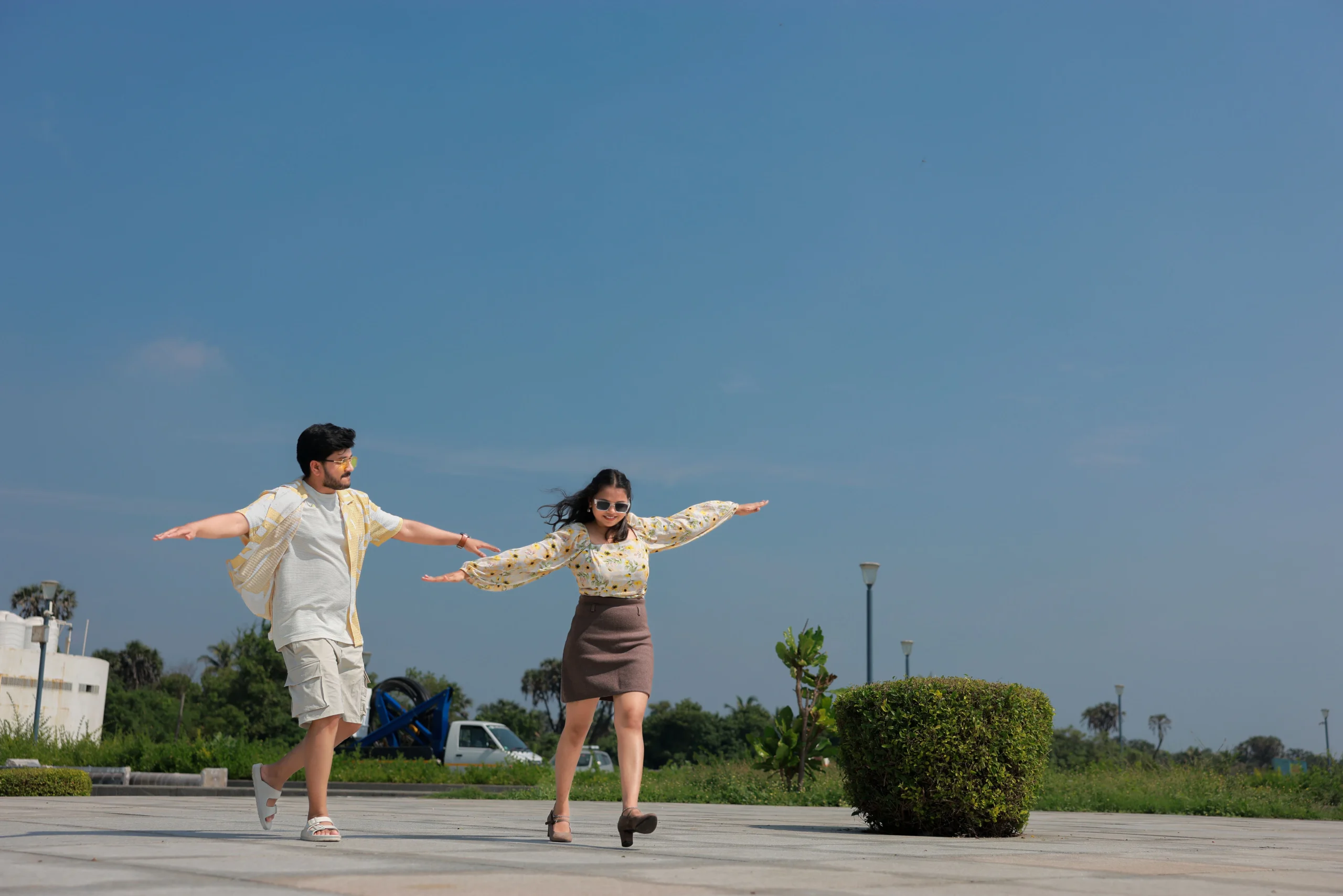 Joyful couple posing outdoors for pre-wedding photography Rajkot, candid pre-wedding shoot, clear sky